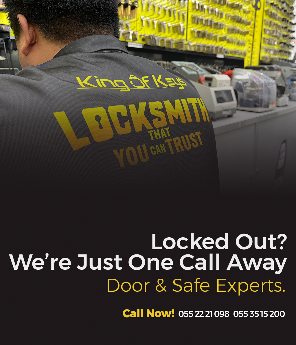 Person wearing a 'King of Keys Locksmith' jacket in a store setting with promotional text.
